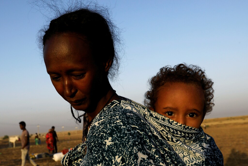 a woman carries a child on her back