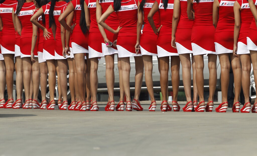 Formula One grid girls wait to enter the pit lane after the third practice session for the first Indian F1 Grand Prix at the Buddh International Circuit in Greater Noida on the outskirts of New Delhi October 29, 2011. REUTERS/Toru Hanai (INDIA - Tags: SPORT MOTOR RACING) - LM2E7AT1D7701
