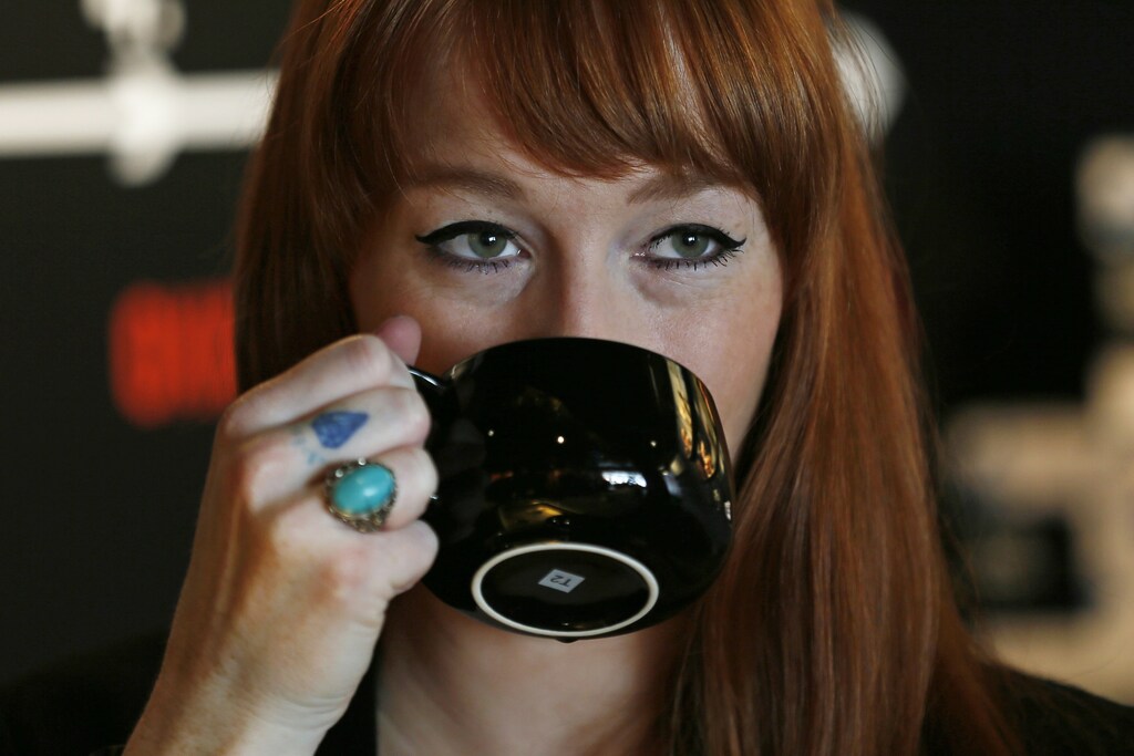 A woman drinks tea in a T2 shop in London April 24, 2014. Consumer goods giant Unilever is testing its might as a high-end retailer by opening the first European outpost of Australia's T2 tea chain on Thursday in London, hoping to reignite Britons' fading romance with the once-sacred cuppa. REUTERS/Stefan Wermuth (BRITAIN - Tags: BUSINESS FOOD SOCIETY) - LM1EA4O17L801