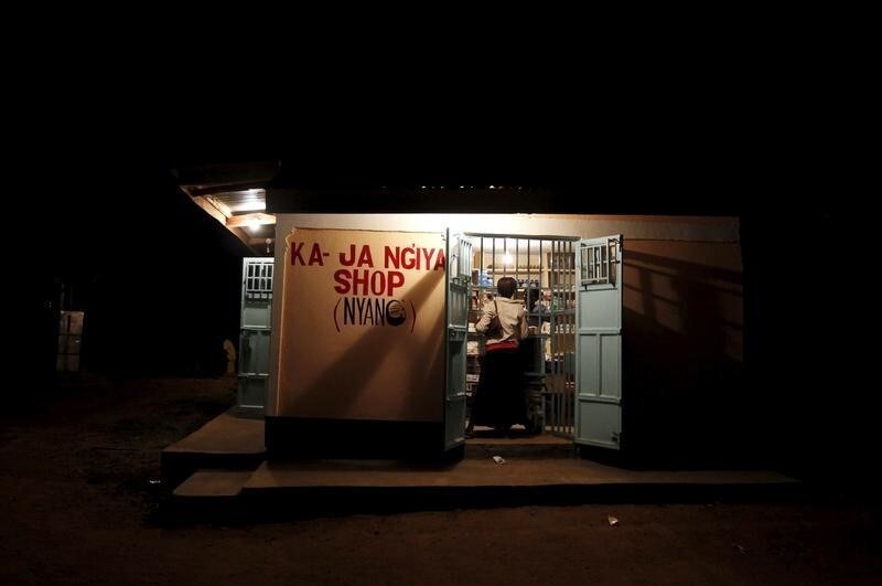 A woman is seen at a shop within the trading centre of the village of Kogelo, west of Kenya's capital Nairobi, July 15, 2015. U.S. President Barack Obama visits Kenya and Ethiopia later this month. His ancestral home of Kogelo is home to Sarah Hussein Obama, his step-grandmother. The Kenyan village, burial place of Obama's father, features an open-pit goldmine, a pork butcher's, a school named after their most famous son and outdoor market stalls. Villagers get around by motorbike taxi or on foot while a donkey-cart transports water. Children, some of them named Obama in honour of the President, walk to and from school together. Picture taken July 15, 2015. REUTERS/Thomas MukoyaPICTURE 25 OF 35 FOR WIDER IMAGE STORY "KOGELO, KENYA - OBAMA'S ANCESTRAL HOME". SEARCH "ANCESTRAL MUKOYA" FOR ALL IMAGES - RTX1LGZQ