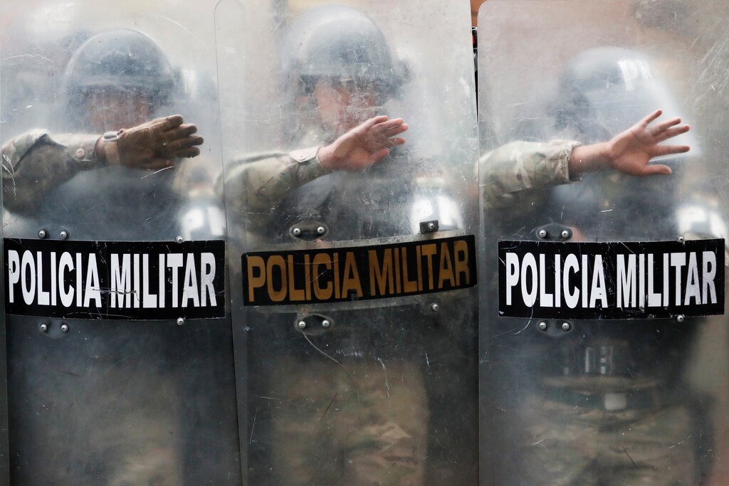 Military Police officers stand guard as supporters of former Bolivian President Evo Morales take part in a protest in La Paz, Bolivia November 14, 2019. REUTERS/Carlos Garcia Rawlins TPX IMAGES OF THE DAY - RC29BD93UV91