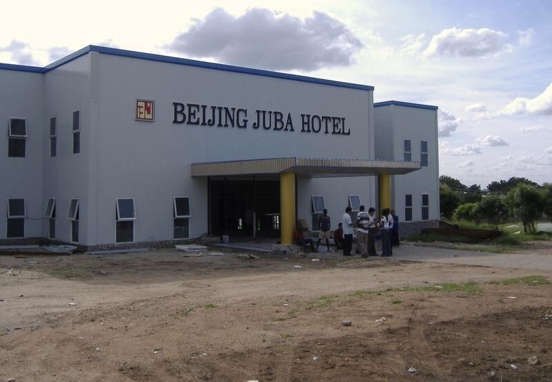 Chinese investors stand outside the Beijing Juba hotel in South Sudan's capital Juba in this August 20, 2007 file photo. Chinese businessmen are taking a long-term view and pursuing strategic expansion in Africa even though China's multiplying investments on the continent have lost some lustre in the recent global downturn. Picture taken on July 7, 2008.