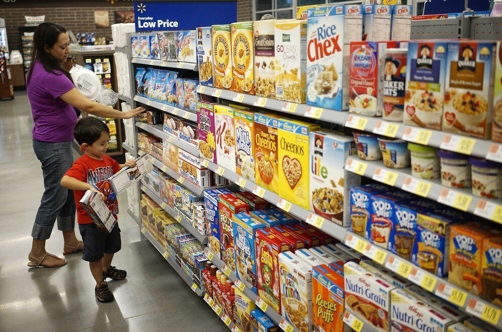 A woman and child shop at a Walmart to Go convenience store which is open on a trial basis in Bentonville, Arkansas June 5, 2014. The new Walmart to Go stores will carry 3,500 of the products the regular Walmart stores carry at similar prices.