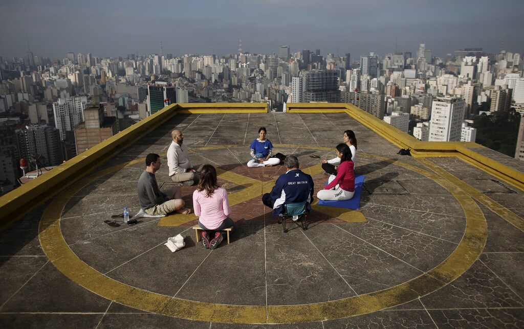 People meditate on the helipad of Copan building to celebrate World Health Day, which was observed on April 7, in downtown Sao Paulo April 9, 2015. REUTERS/Nacho Doce - GF10000053642