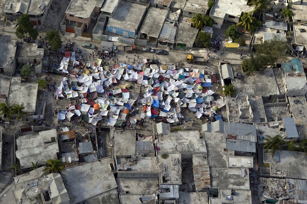 A group of tents stands amidst the rubble after an earthquake in Port-au-Prince, in this United Nations handout taken January 12, 2010. The number of U.N. military and police officials confirmed to have been killed in the Haiti earthquake now stands at 22, U.N. Secretary-General Ban Ki-moon said on Thursday. Picture taken January 12. REUTERS/UN Photo Logan Abassi/Handout (HAITI ENVIRONMENT - Tags: DISASTER POLITICS IMAGES OF THE DAY) ENVIRONMENT) FOR EDITORIAL USE ONLY. NOT FOR SALE FOR MARKETING OR ADVERTISING CAMPAIGNS - GM1E61F02PZ01