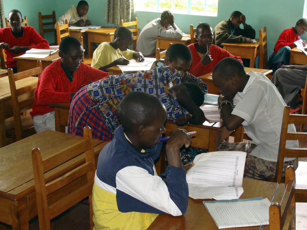 Maasai girls study inside a classroom at Emusoi Centre in Arusha January 24, 2008. A remedial school for 13-to-18-year-old girls, the center was founded by Catholic missionaries with the help of one of Tanzania's few female Maasai college graduates, and is now home to 75 Maasai girls. Since it opened in 1998 Emusoi, a Maasai word meaning "discovery", has placed more than 400 in 80 boarding schools across Tanzania after housing them for one year. Of the 240 or so Maasai girls who started secondary school in the country last year, 119 had been through Emusoi. Picture taken January 24, 2008. To match feature TANZANIA-SCHOOL/ REUTERS/David Conrad (TANZANIA)