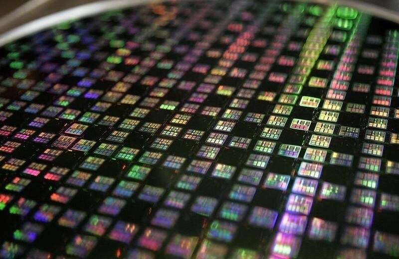 A 12-inch wafer is displayed at Taiwan Semiconductor Manufacturing Company (TSMC) in Xinchu January 9, 2007. TSMC, the world's top contract chip maker, posted an 18.4 percent fall in December sales on January 10, hurt by clients' unwanted stockpiles, but a recovery looms as a new crop of electronics devices hit store shelves. Picture taken January 9, 2007. REUTERS/Richard Chung (TAIWAN) - RTR1L1ID
