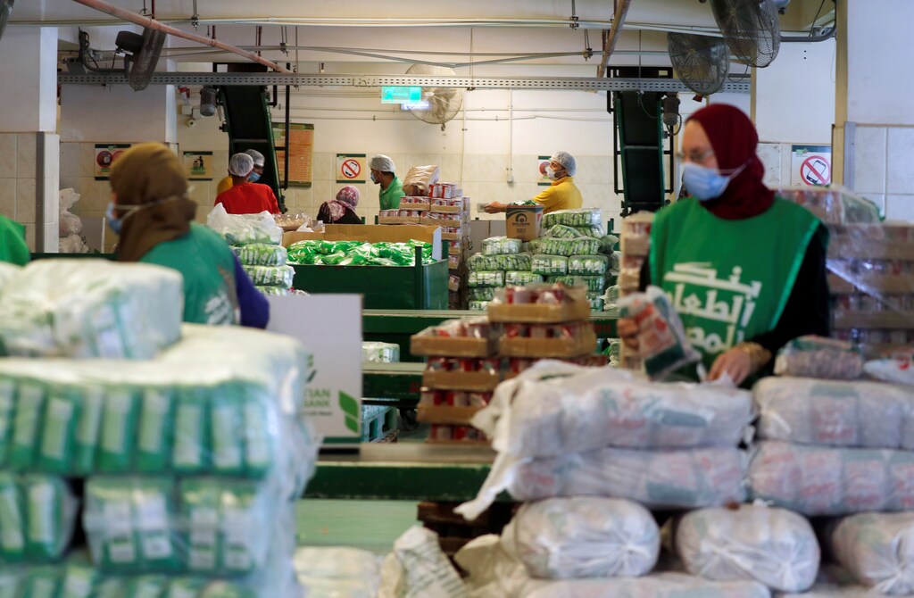 Workers of the Egyptian Food Bank fill boxes with food and aid for needy families and people who have lost their jobs due to the outbreak of the coronavirus disease (COVID-19), during the Muslim holy month of Ramadan in Cairo, Egypt April 29, 2020. Picture taken April 29, 2020. REUTERS/Amr Abdallah Dalsh - RC2YGG95FBRK