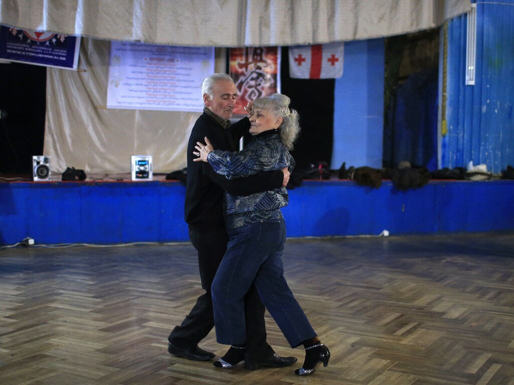 Tsira Tsagareli (R), 66, dances with Jemal Nemsitsveridze, 77, during a class at the Fortune dance club in Tbilisi January 29, 2015. Eliso Bakuradze, 79, who has been dancing since her school years, established the club 10 years ago. About 20 people, mostly pensioners, gather at the club three times a week to enjoy dancing. REUTERS/David Mdzinarishvili (GEORGIA - Tags: SOCIETY) - GM1EB1U06M601