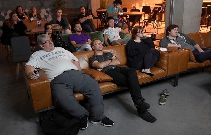 Residents or 'members' relax in a shared space to watch a weekly screening of the series 'Game of Thrones' on a large screen at The Collective co-living building in west London, August 14, 2017. Picture taken August 14, 2017. REUTERS/Toby Melville - RC1447BAE7F0