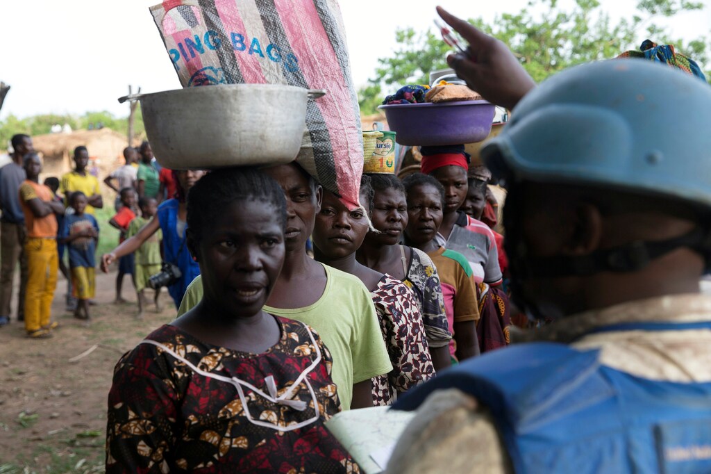 A Cameroonian United Nations peacekeeper talks to women fleeing the village of Zike as they arrive to the village of Bambara, Central African Republic, April 25, 2017. picture taken April 25, 2017. REUTERS/Baz Ratner - RTS13XW6