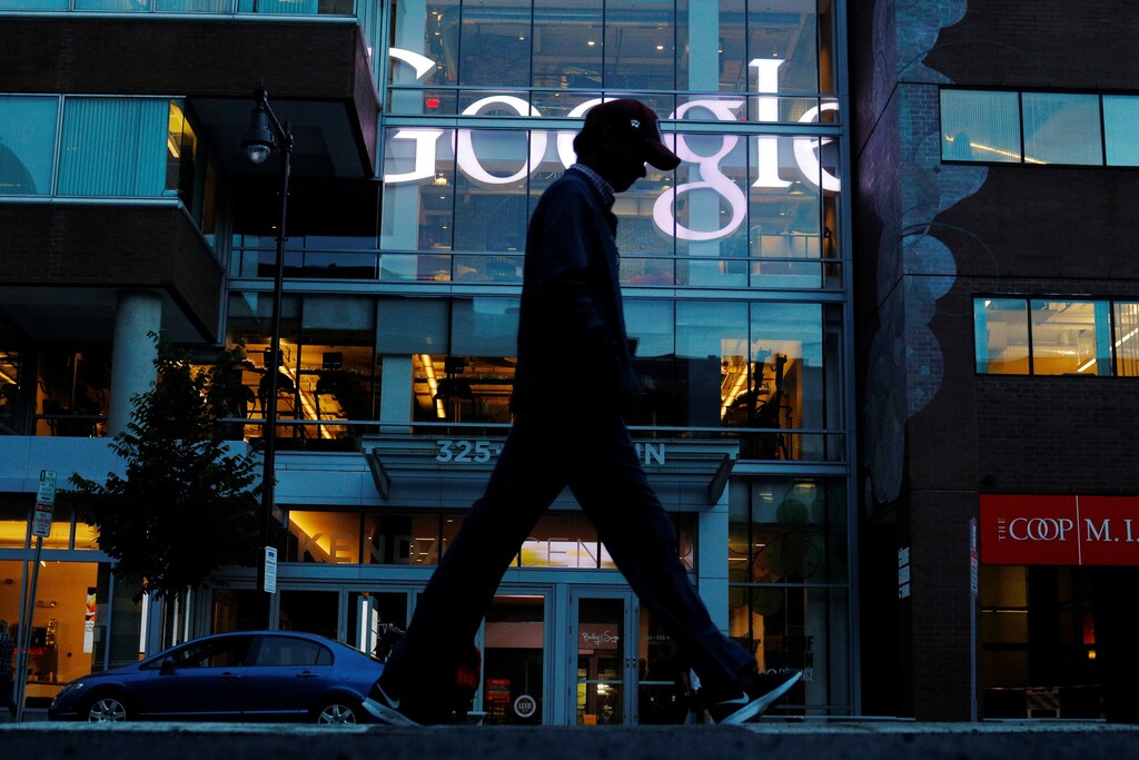 A pedestrian walks past the Google offices in Cambridge, Massachusetts, U.S., June 27, 2017. This logo has been updated and is no longer in use. REUTERS/Brian Snyder - RC19229EBB50