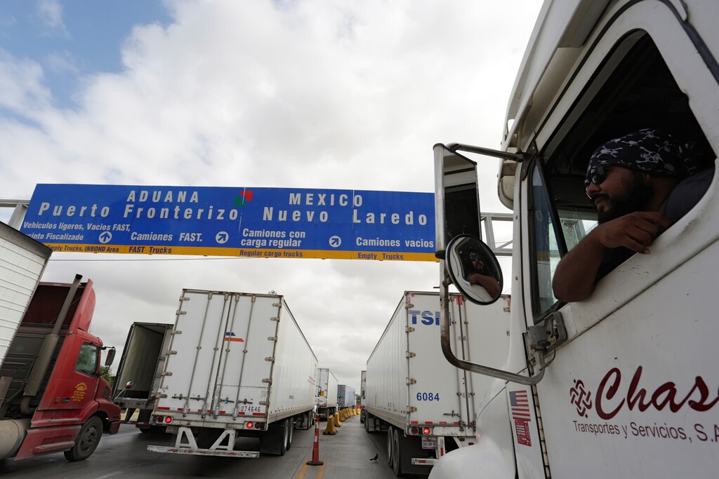 A driver leans out the cabin window while waiting in a queue for border customs control to cross into U.S. at the World Trade Bridge in Nuevo Laredo, Mexico, November 2, 2016.