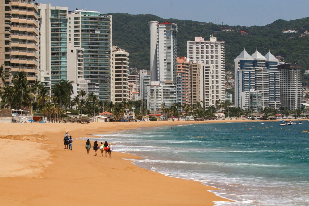 Tourists walk along a beach during the reopening of the beaches and hotels after confinement measures were eased this week, as the coronavirus disease (COVID-19) outbreak continues in Acapulco, Mexico July 2, 2020.