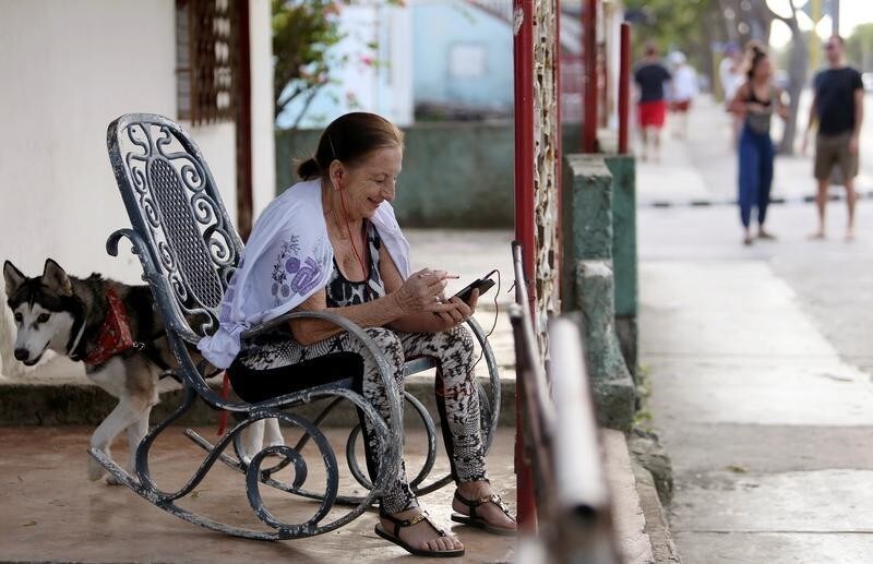 Yudaris Aleman speaks to her daughter who lives in Canada, via a mobile device in Varadero, Cuba, December 6, 2018. Picture taken on December 6, 2018. REUTERS/Fernando Medina - RC1E48A271D0