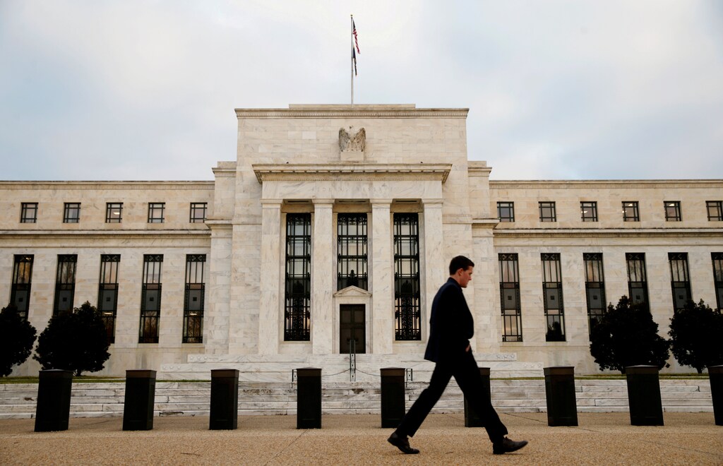 FILE PHOTO: A man walks past the Federal Reserve Bank in Washington, D.C., U.S. December 16, 2015. REUTERS/Kevin Lamarque/File Photo GLOBAL BUSINESS WEEK AHEAD PACKAGE Ð SEARCH BUSINESS WEEK AHEAD MARCH 13 FOR ALL IMAGES - RTX30QIT