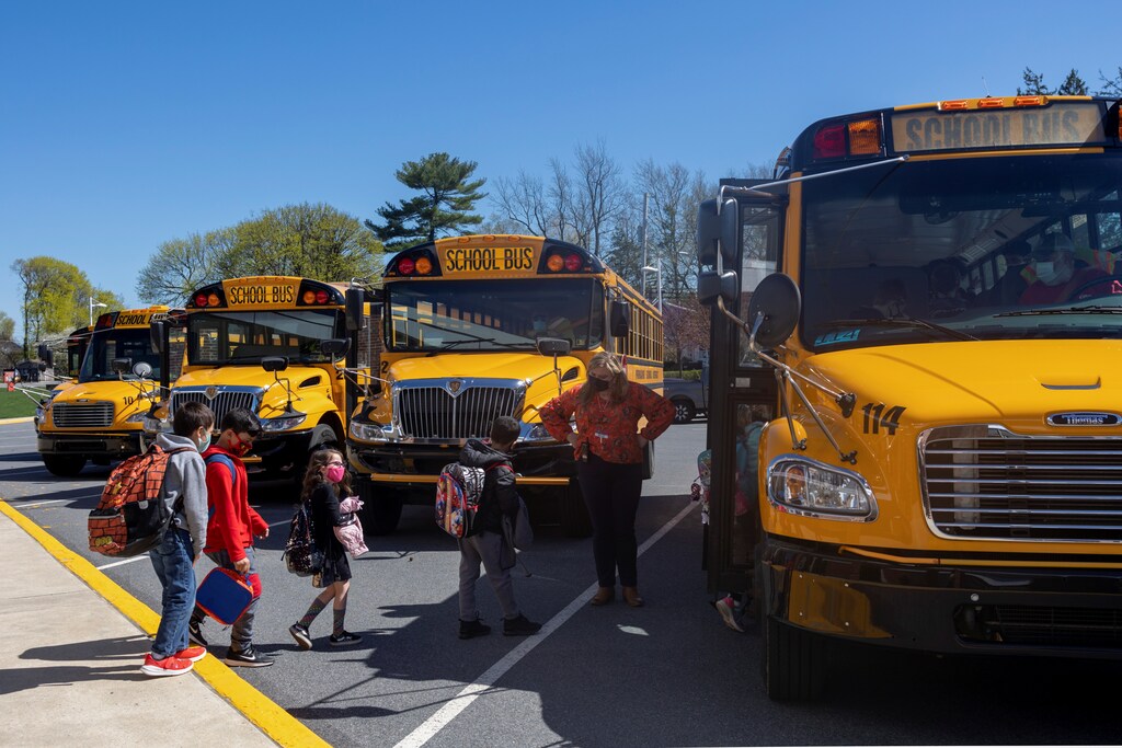 Students getting on school buses.