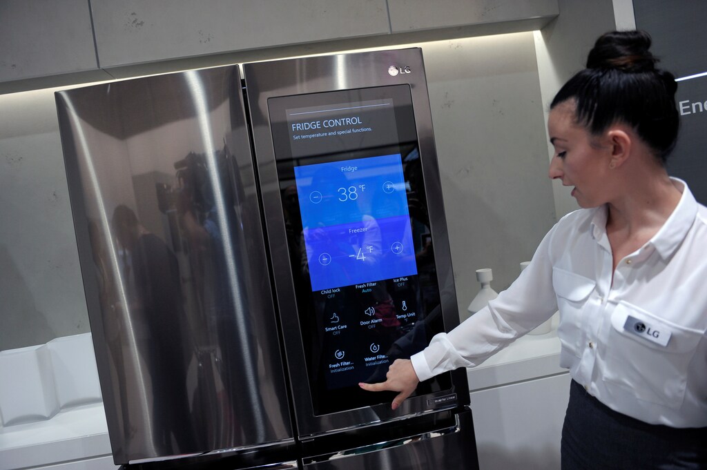An assistant presents a smart home refridgerator by LG at the IFA Electronics show in Berlin, Germany September 2, 2016. REUTERS/Stefanie Loos - D1BETYYZHZAB