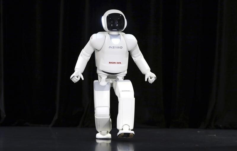 Honda's latest version of the Asimo humanoid robot runs during a presentation in Zaventem near Brussels July 16, 2014. Honda introduced in Belgium an improved version of its Asimo humanoid robot that it says has enhanced intelligence and hand dexterity, and is able to run at a speed of some 9 kilometres per hour (5.6 miles per hour). REUTERS/Francois Lenoir (BELGIUM - Tags: SCIENCE TECHNOLOGY BUSINESS SOCIETY) - RTR3YVQI
