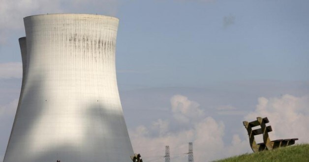 People look at the cooling towers of Doel's nuclear plant in northern Belgium August 20, 2014. Two Belgian nuclear reactors owned by GDF-Suez unit Electrabel may remain offline until spring and may need to be halted permanently, Belgian state broadcaster VRT reported on Tuesday. The Belgian nuclear regulator ordered production to be stopped at the 1,008 megawatt Tihange 2 reactor and the 1,006 megawatt Doel 3 reactor in 2012 after finding indications of cracks in their core tanks. Electrabel was not immediately available for comment. REUTERS/Francois Lenoir