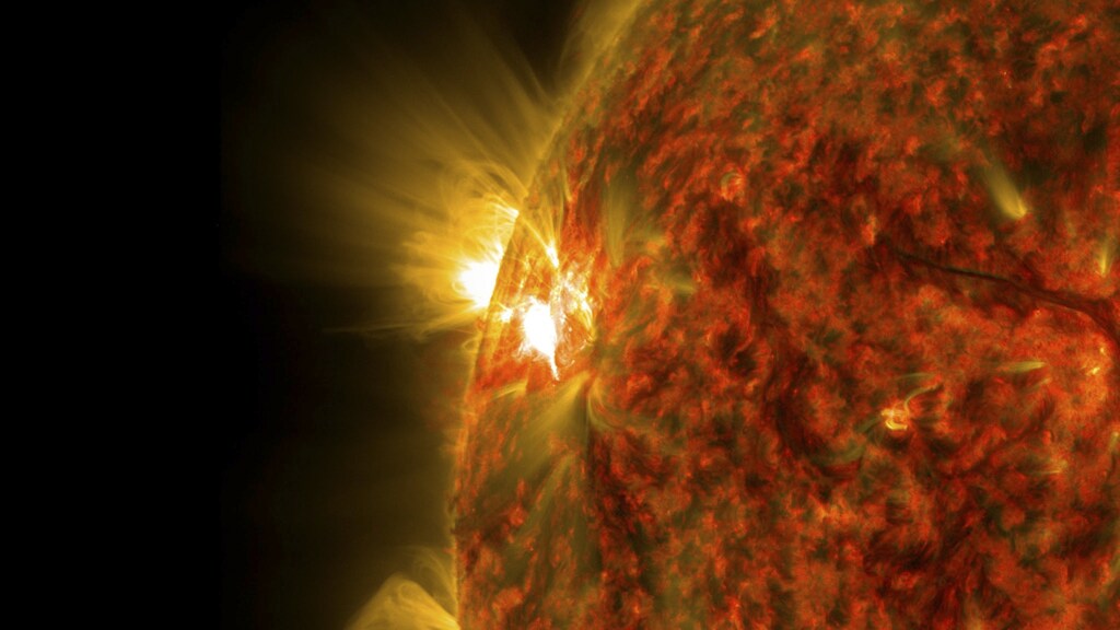 An active region on the sun emitting a mid-level solar flare, peaking at 04:47EST (09:47GMT) is seen in an image was captured by NASA's Solar Dynamics Observatory (SDO) November 5, 2014. This is the second mid-level flare from the same active region, labeled AR 12205, which rotated over the left limb of the sun on November 3. REUTERS/NASA/SDO/Handout via Reuters (OUTER SPACE - Tags: SCIENCE TECHNOLOGY) THIS IMAGE HAS BEEN SUPPLIED BY A THIRD PARTY. IT IS DISTRIBUTED, EXACTLY AS RECEIVED BY REUTERS, AS A SERVICE TO CLIENTS. FOR EDITORIAL USE ONLY. NOT FOR SALE FOR MARKETING OR ADVERTISING CAMPAIGNS - RTR4D4QA
