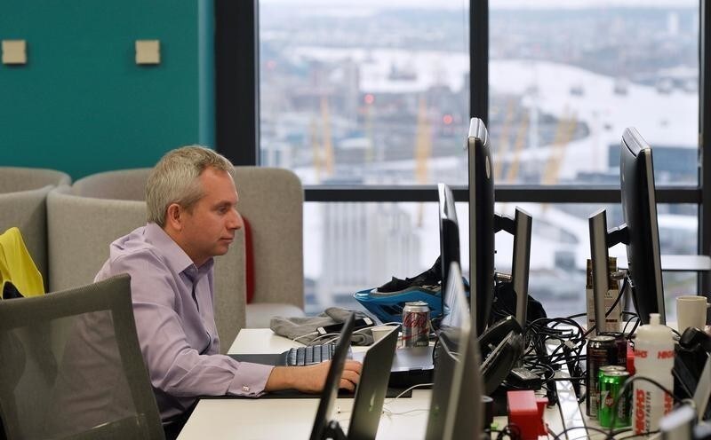A UBS employee works in the UBS "fintech lab" at Canary Wharf in London, Britain, October 19, 2016. REUTERS/Hannah McKay - D1BEUHXBVIAA