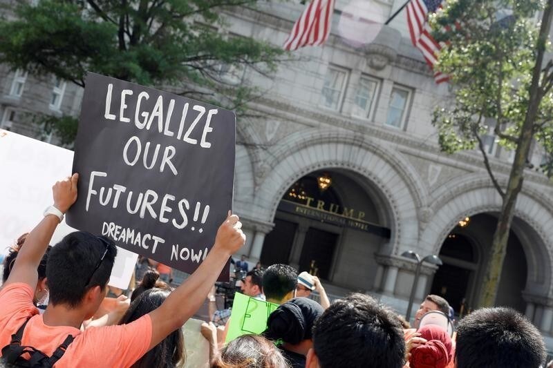 Protestors gather outside the Trump International Hotel to protest President Donald Trump's plan to repeal DACA in Washington, U.S., September 5, 2017. REUTERS/Aaron P. Bernstein - RC125146C660