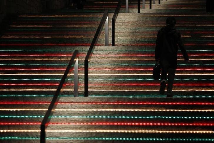 A businessman walks up a staircase at a business complex in Tokyo December 1, 2010. Business sentiment at Asia's top companies rebounded in the fourth quarter as corporations shrugged off concerns that the debt crisis unfolding on Europe's fringes will hobble global growth. Picture taken December 1, 2010. To match ASIA-COMPANIES/SENTIMENT REUTERS/Yuriko Nakao (JAPAN - Tags: EMPLOYMENT BUSINESS)
