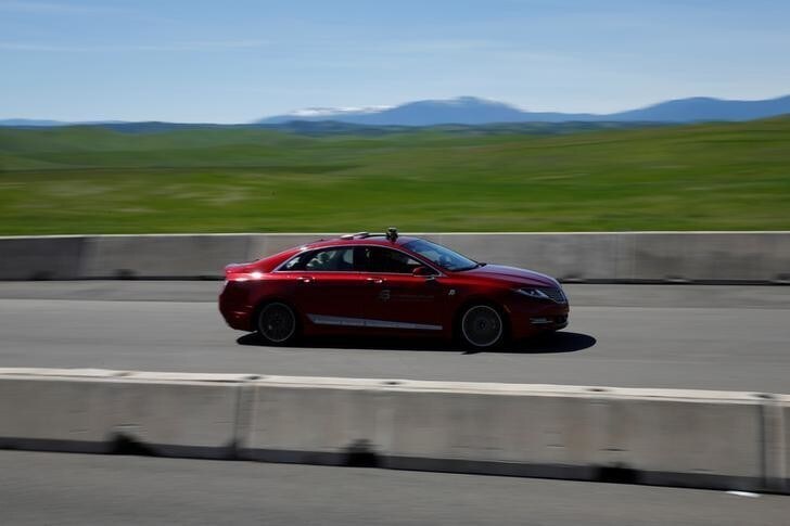 An AutonomouStuff Automated Research Development Vehicle drives on the race track during a self-racing cars event at Thunderhill Raceway in Willows, California, U.S., April 1, 2017. REUTERS/Stephen Lam