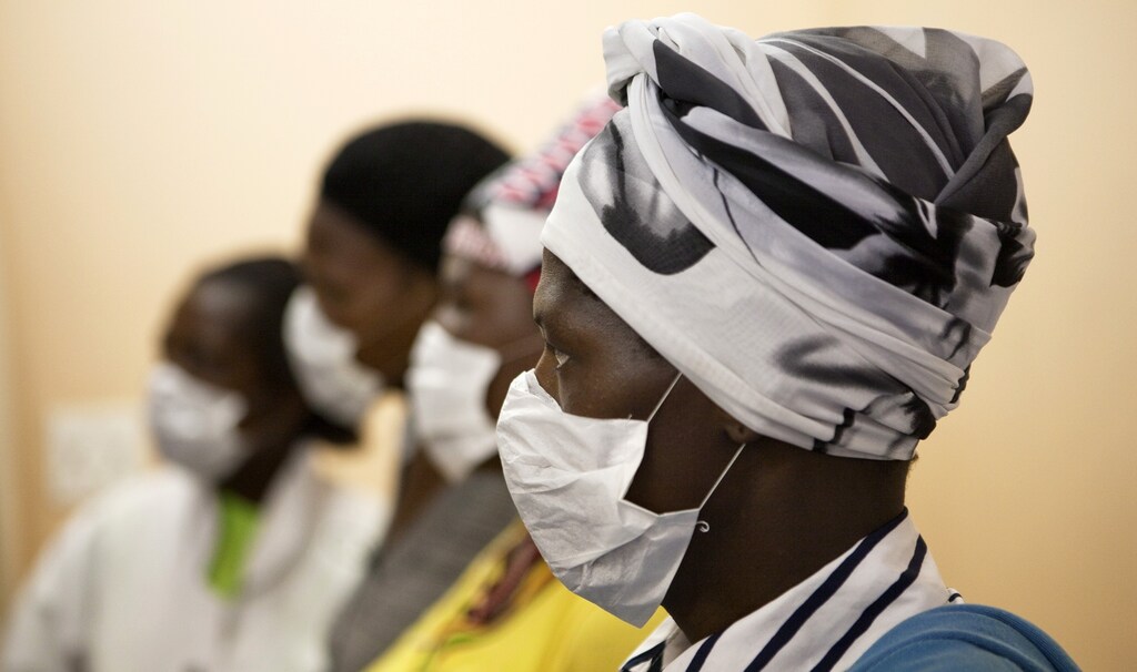 Patients with HIV and tuberculosis (TB) wear masks while awaiting consultation at a clinic in Cape Town's Khayelitsha township, February 23, 2010.