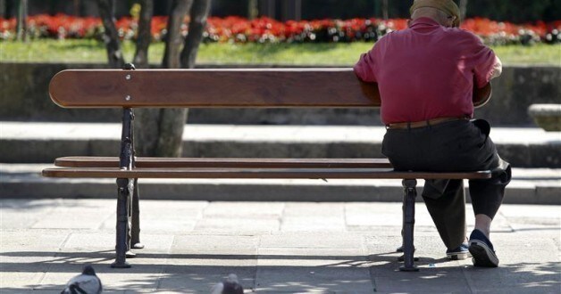 A man sits on a bench in central Pontevedra September 18, 2012. Spain is considering freezing pensions and speeding up a planned rise in the retirement age as it races to cut spending and meet conditions of an expected international sovereign aid package, sources with knowledge of the matter said. Picture taken September 18. REUTERS/Miguel Vidal
