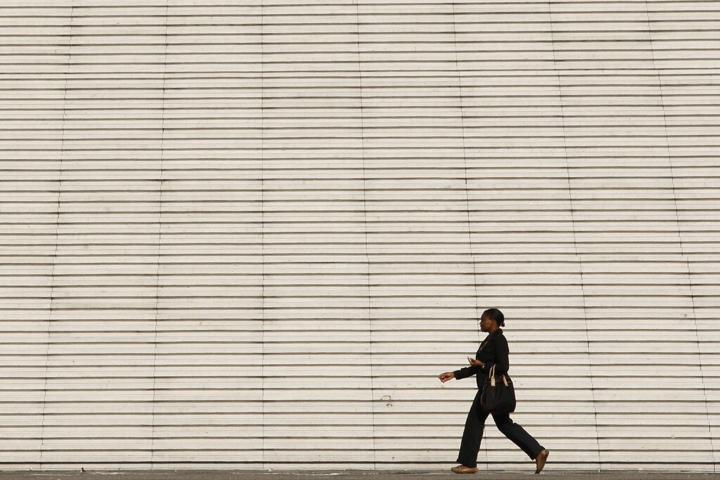 businesswoman walks past the steps at the Arche de la Defense, the financial and business district west of Paris.