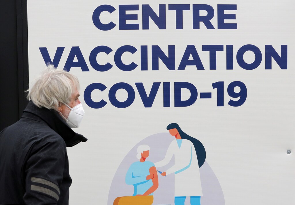 A man wearing a mask by a COVID-19 vaccination centre