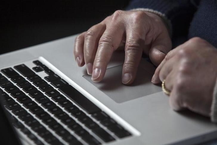 John Bumgarner, a cyber warfare expert who is chief technology officer of the U.S. Cyber Consequences Unit, a non-profit group that studies the impact of cyber threats, works on his laptop computer during a portrait session in Charlotte, North Carolina December 1, 2011. A cyber warfare expert claims he has linked the Stuxnet computer virus that attacked Iran's nuclear program in 2010 to Conficker, a mysterious worm that surfaced in late 2008 and infected millions of PCs. Conficker was used to open back doors into computers in Iran, then infect them with Stuxnet, according to research Bumgarner, a retired U.S. Army special-operations veteran and former intelligence officer. To match Insight - CYBERSECURITY/IRAN REUTERS/John Adkisson (UNITED STATES - Tags: SCIENCE TECHNOLOGY MILITARY)