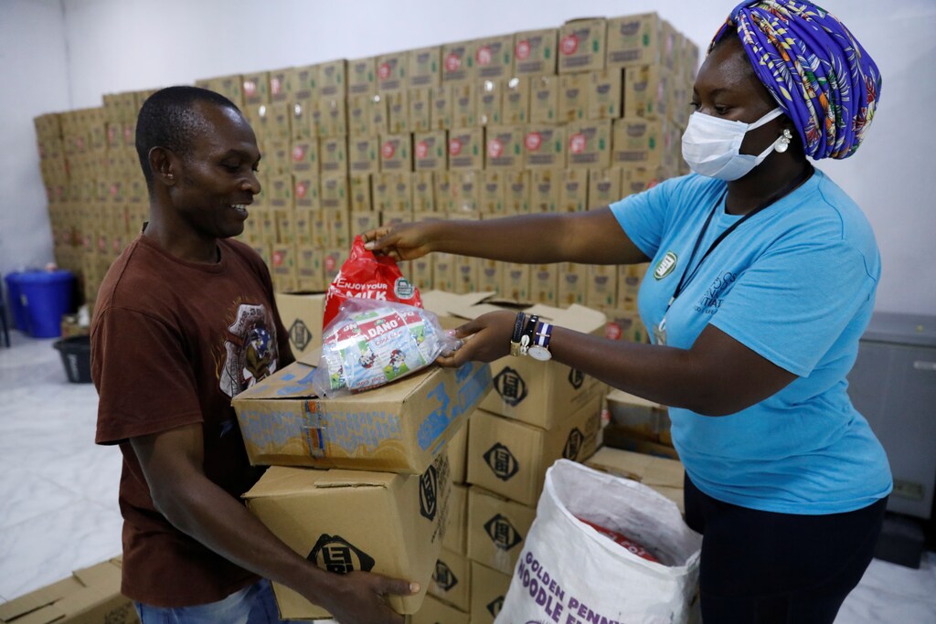 Desmond Okorie, a beneficiary of the food aid distribution by the Lagos food bank inititative, receives food supplies at the food bank warehouse in Lagos, Nigeria July 10, 2021