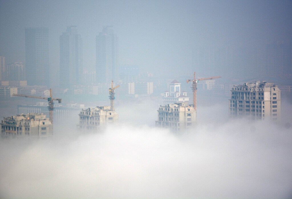Buildings under construction are seen during a hazy day in Rizhao, Shandong Province, China, March 15, 2016.