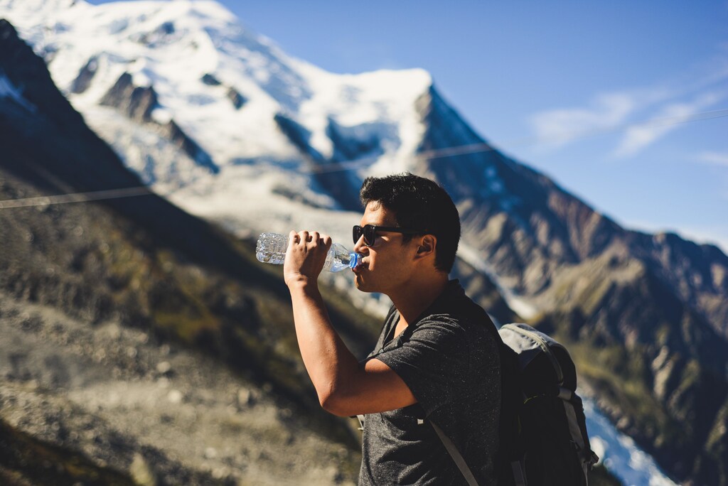 A man drinking from a bottle of water.