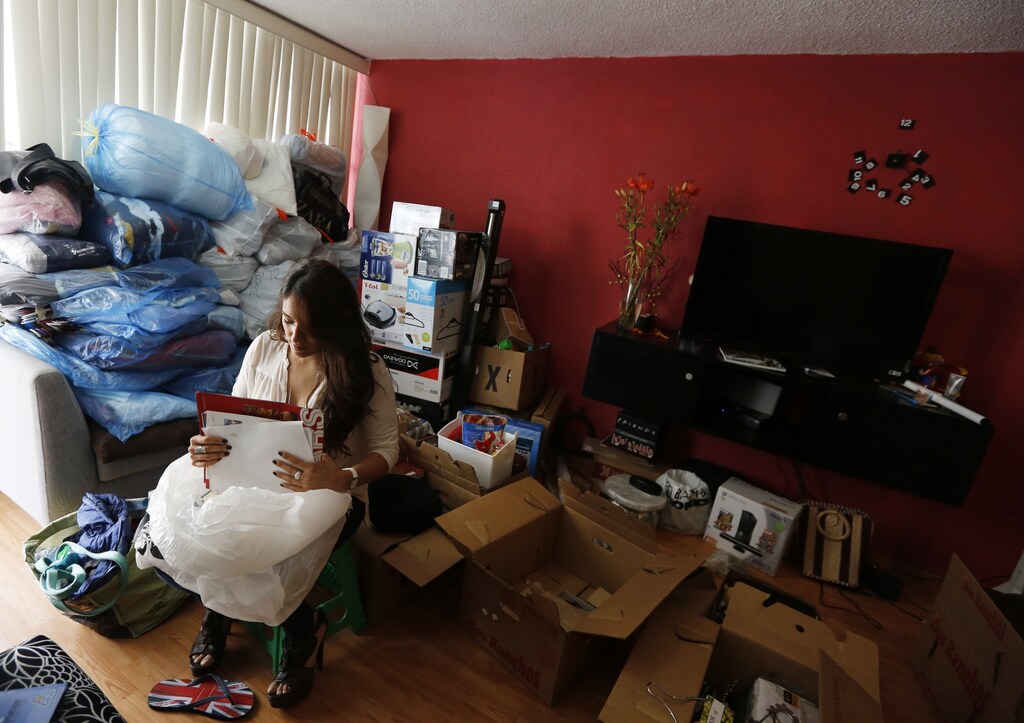 Tatiana, a licensing compliance expert at a software firm, packs for a move to a new house with her partner in Mexico City July 7, 2013. Couples with dual incomes but no kids, or "Dinks," are on the rise in Mexico, nearly doubling since 2005. They are buoying a growing high-end goods market, splashing out on everything from expensive lingerie to home decor. Though just over a million in number, the couples are a gold mine for leading brands, and their spending habits are shoring up consumer demand as Mexico's economy cools. Picture taken July 7, 2013. REUTERS/Bernardo Montoya (MEXICO - Tags: SOCIETY) - RTX11MJO