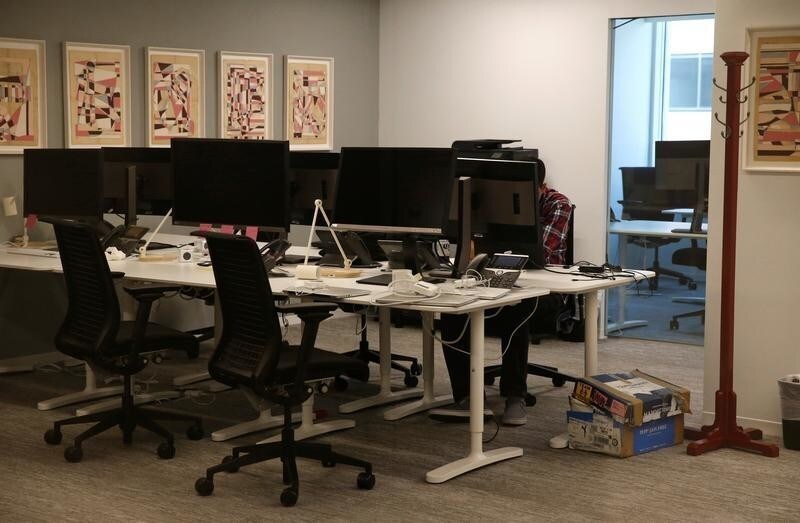 A person works on a laptop in the empty offices of Cambridge Analytica in Washington, D.C., U.S., May 2, 2018. REUTERS/Leah Millis - RC1CC8CE9230