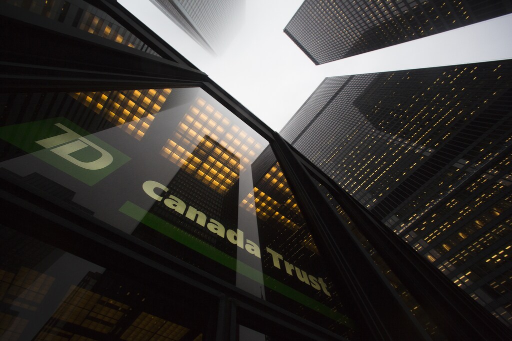 A TD Canada Trust branch is seen in the financial district in Toronto, January 28, 2013. Moody's Investors Service has cut the ratings of six Canadian financial institutions, including the previously "Aaa" rated Toronto-Dominion Bank, due to concerns about rising consumer debt and high housing prices. TD, the only publicly traded bank that still carried Moody's top rating, was downgraded, along with Bank of Nova Scotia , Canadian Imperial Bank of Commerce, Bank of Montreal, National Bank of Canada and Caisse Central Desjardins, Canada's largest association of credit unions, Moody's said on Monday. REUTERS/Mark Blinch (CANADA - Tags: BUSINESS POLITICS TPX IMAGES OF THE DAY) - GM1E91T0LJI01