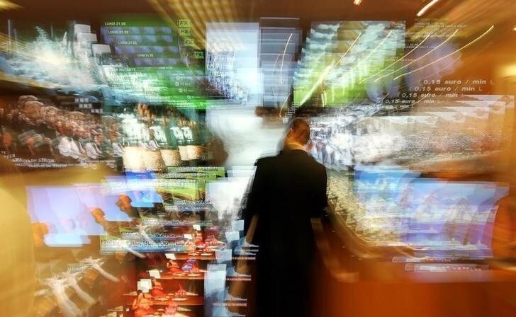 A man stands in front of a wall of TV screens during the MIPCOM, the international film and programme market for TV, video, cable and satellite October 4, 2004. REUTERS/Eric Gaillard NO RIGHTS CLEARANCES OR PERMISSIONS ARE REQUIRED FOR THIS IMAGE EG/JS/AS
