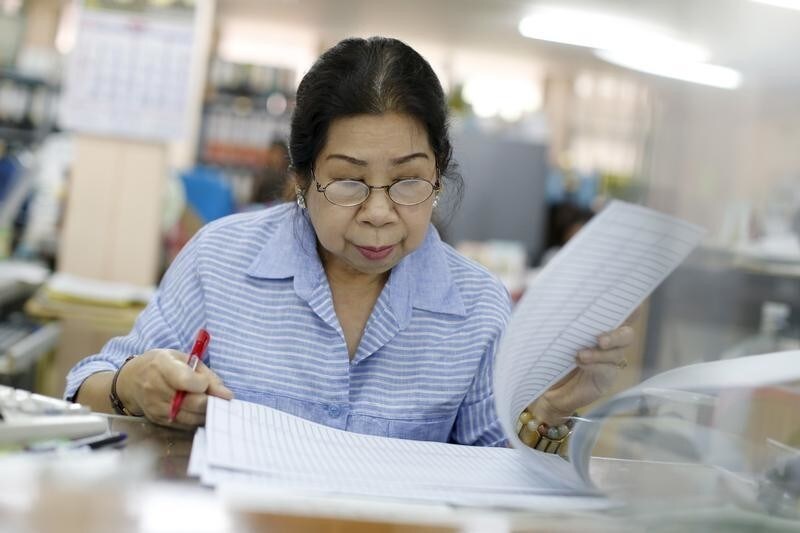 Sunisa Hongaroon, a 67-year-old accountant, works in a transportation company in Bangkok, Thailand, February 3, 2016. The World Bank estimates the working-age population will shrink by 11 percent by 2040, the fastest contraction among Southeast Asia's developing countries. Thailand's stage of economic development, the rising cost of living and education, and a population waiting longer to get married are among the reasons it is ageing more quickly than its neighbours. An effective contraception programme in the 1970s also played a part, said Sutayut Osornprasop, a human development specialist at the World Bank in Thailand. Picture taken February 3, 2016.