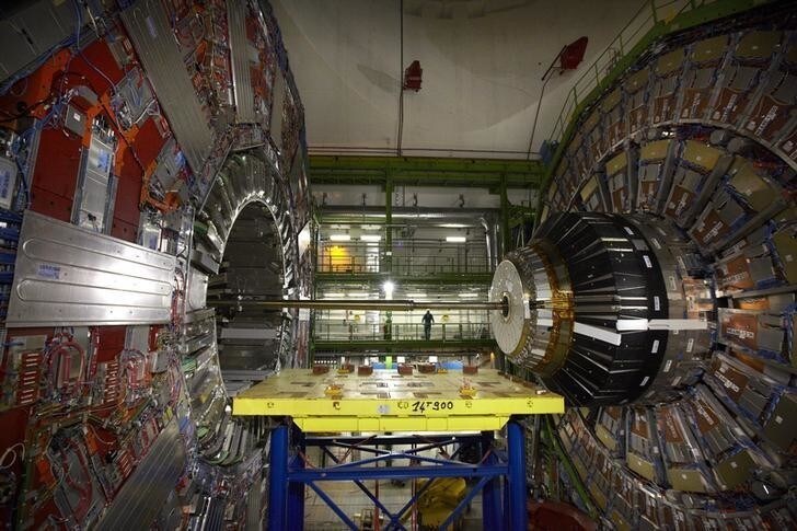 A technician stands near equipment of the Compact Muon Solenoid (CMS) experience at the Organization for Nuclear Research (CERN) in the French village of Cessy near Geneva in Switzerland April 15, 2013. As hundreds of engineers and workers start two years of work to fit out the giant LHC particle collider to reach deep into unknown realms of nature, CERN physicists look to the vast machine to unveil by the end of the decade the nature of the mysterious dark matter that makes up a quarter of the universe and perhaps find new dimensions of space. REUTERS/Denis Balibouse (FRANCE - Tags: TPX IMAGES OF THE DAY SCIENCE TECHNOLOGY)