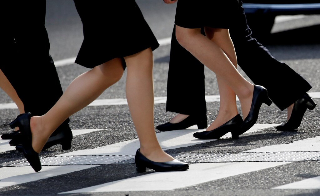 Women in high heels walk at a business district in Tokyo, Japan, June 4, 2019. REUTERS/Kim Kyung-Hoon - RC19E3187290