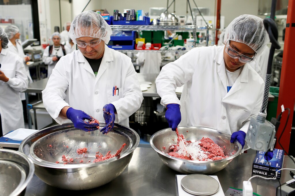 Workers assemble the plant-based hamburger patties during a media tour of Impossible Foods labs and processing plant in Redwood City, California, U.S. October 6, 2016. Picture taken October 6, 2016. REUTERS/Beck Diefenbach - RTSS2TW