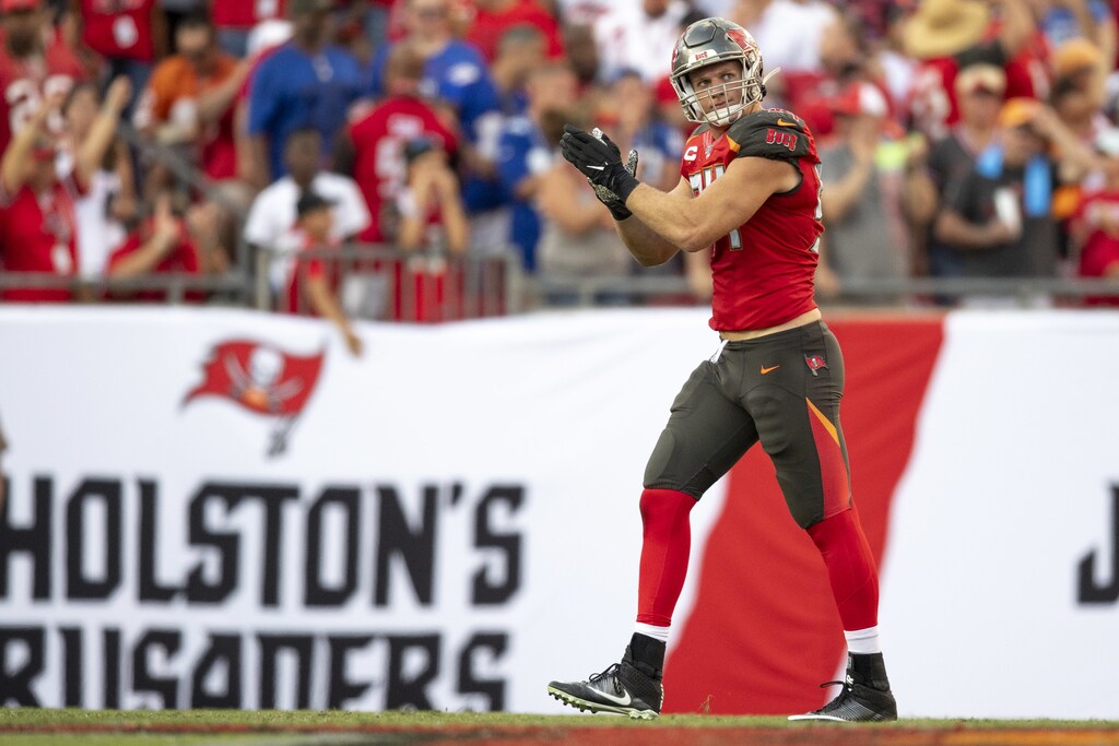a picture of first active NFL player to come out, Carl Nassib playing american football.