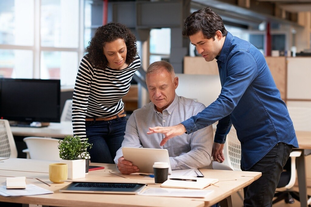 People from different ages working in office