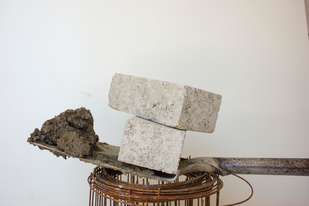 A spade with cement and concrete blocks on