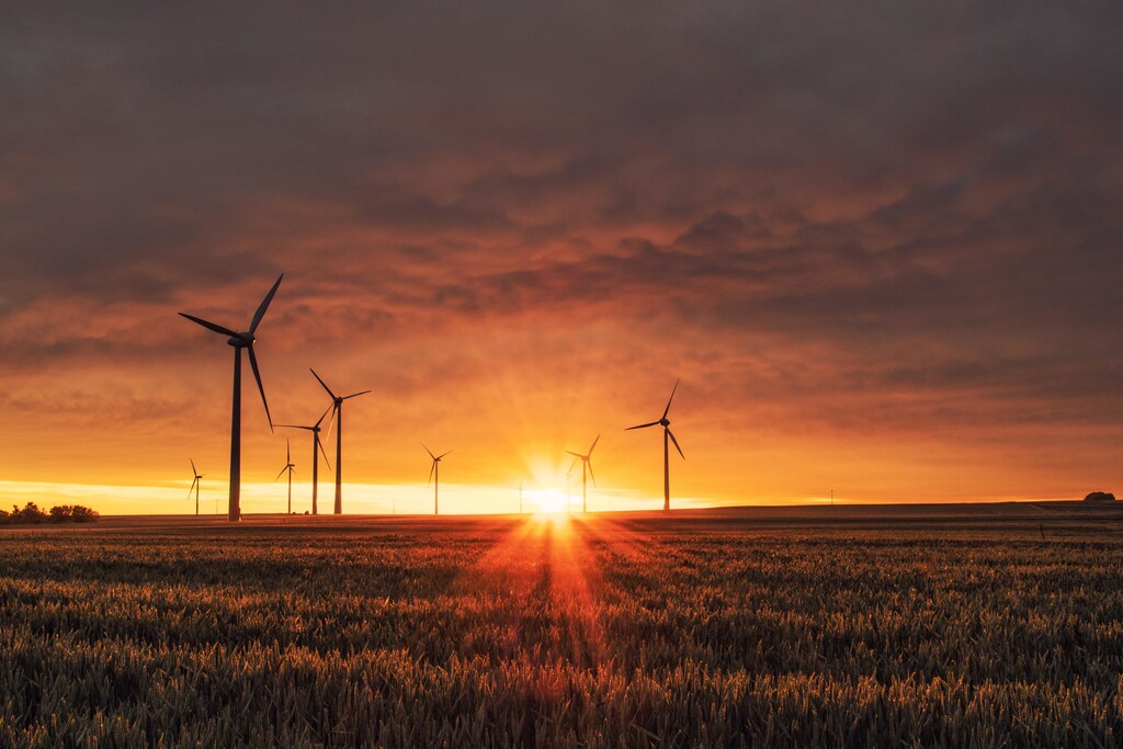 Windmills on grass field during golden hour: Finance is one lever for a just transition.