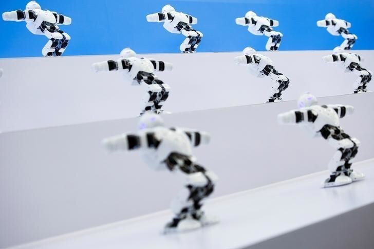 Robots perform a syncronised dance at the 2017 World Robot Conference in Beijing, China August 22, 2017. REUTERS/Thomas Peter
